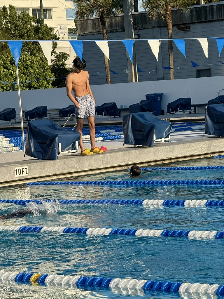 Founder coaching swimmer at pool
